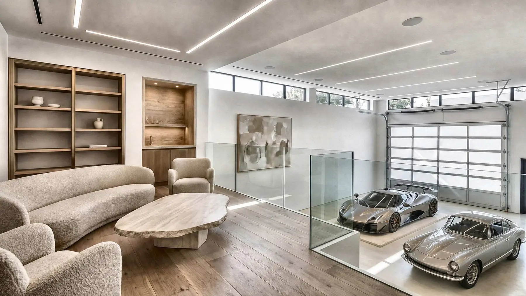 A mezzanine lounge with soft seating and shelving, looking down through a glass rail